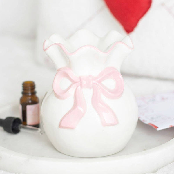 White and pink oil burner with bow