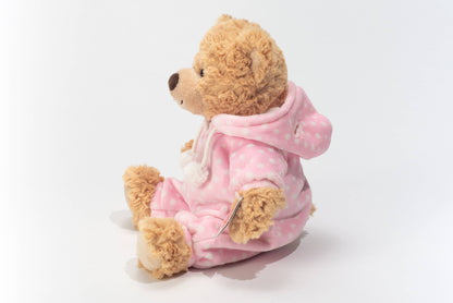 Plush teddy bear in pink pajamas
