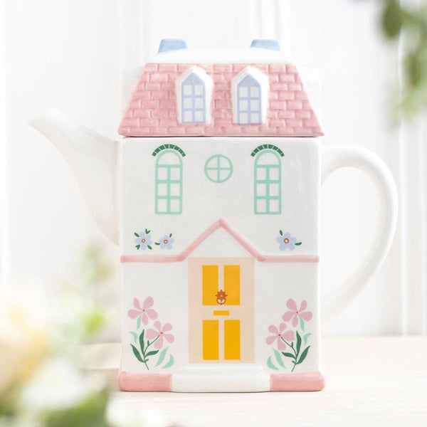 Pastelkleurige theepot in de vorm van een huis