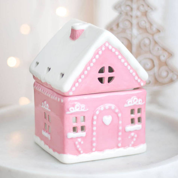 Roze peperkoekhuisje kerstoliebrander
