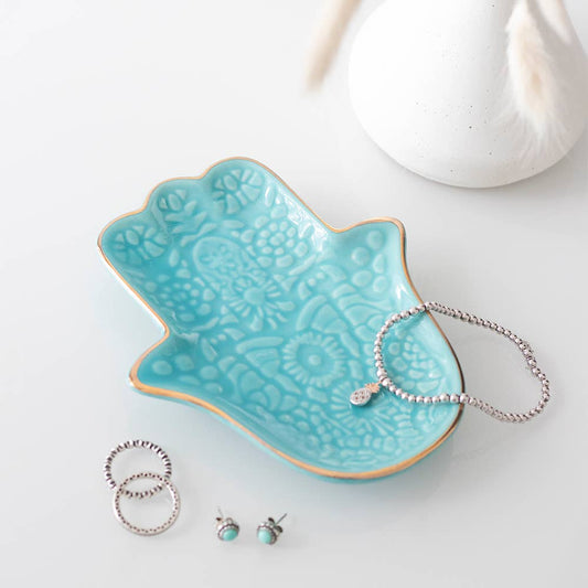 Small turquoise ceramic jewelry dish in the shape of a Hamsa hand