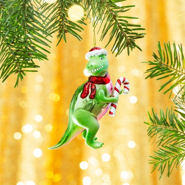 Kerstbal in de vorm van een T-Rex met een zuurstok.